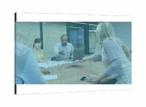 Discussing team in business attire analyzing financial data at table in meeting room with documents