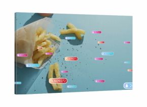 Presenting white parchment cone holding pepper-flecked fries on blue table, UI badges, copy space