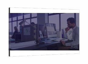 Leaning Middle Eastern man focusing on screen in open plan office with mouse, copy space