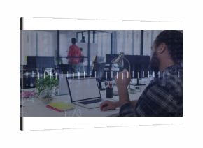 Office worker typing in coworking office, with laptop, lamp, plant and notebooks, copy space