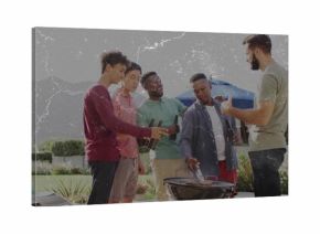 Grilling group of five friends turning meats on charcoal grill at poolside patio, with summer wear