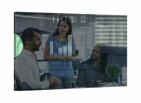 Collaborating colleagues reviewing analytics at computer monitor in office, displaying data charts
