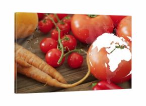 Displaying fresh vegetables on wooden tabletop, with map overlay and globe graphic