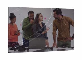 Four professionals reviewing project in meeting room with sticky note whiteboard, with laptop drone