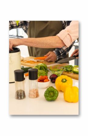 Preparing fresh vegetables, mature couple cooking together in modern kitchen, at home