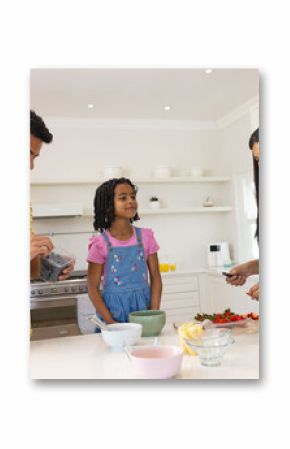 In kitchen, family preparing breakfast together, sharing quality time and fresh fruit