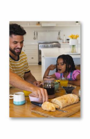 Family enjoying breakfast together at home, smiling and sharing food around table