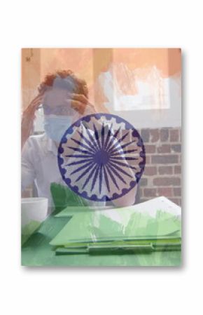 Composition of tired businessman wearing face mask in office over indian flag