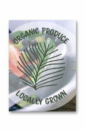 Image of organic produce locally grown text banner over bowl of fruit salad on wooden table