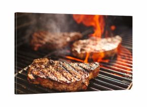 steaks cooking over flaming grill