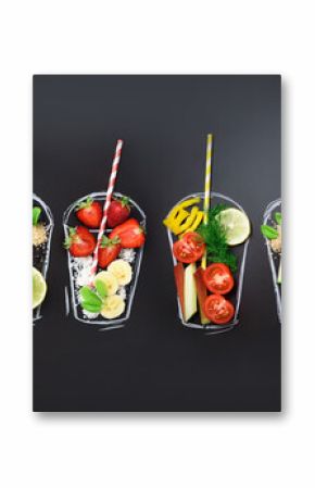 Food ingredients for blending smoothie or juice on painted glass over black chalkboard. Top view with copy space. Organic fruits, vegetables. Vegetarian, vegan, detox, clean eating concept