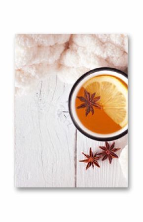 Lemon spice tea, top view on a white wood background with blanket. Cozy fall or winter theme.