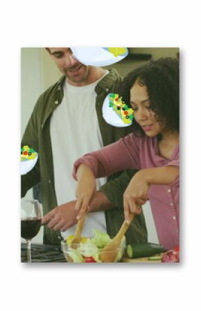 Image of salad icons over happy diverse couple cooking
