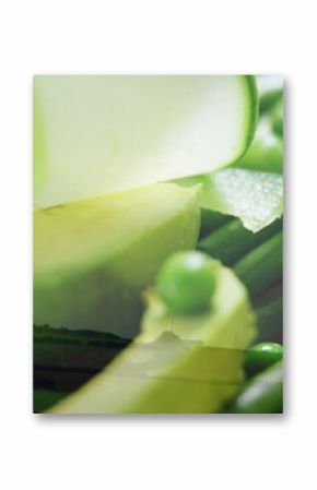 Displaying close-up of avocado slices, cucumber ribbons, green peas over fields, with wind turbine