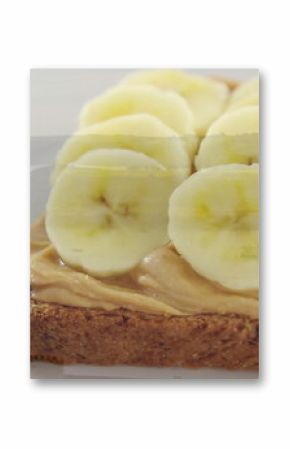 Displaying whole grain toast with peanut butter and banana slices on decorative plate with knife