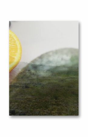 Displaying half orange slice and whole avocado sitting on kitchen countertop, with scattered seeds