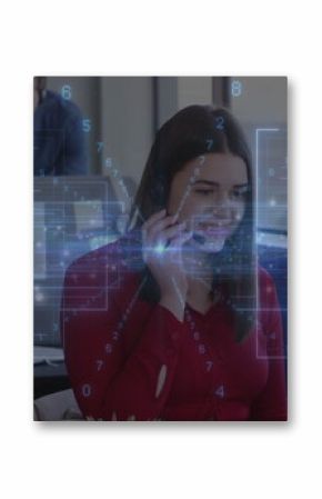 Speaking agent wearing red blouse and headset handling call at office desk, with monitor, papers