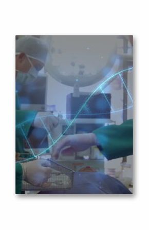 Performing surgery three surgeons wearing green scrubs operating on patient in OR, with DNA helix