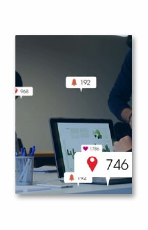 Collaborating coworkers typing at laptops and writing on notepads in boardroom, notification icons