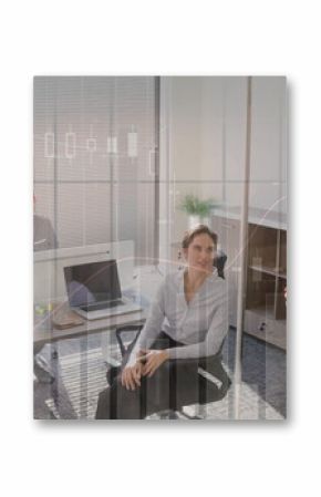 Presenting businesswoman writing on glass board in office meeting with laptop, copy space