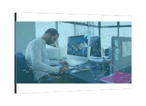 Writing Middle Eastern man in business shirt at office desk with computer, plant, copy space