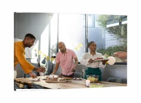 Friends preparing dinner table with decorations, enjoying festive gathering at home