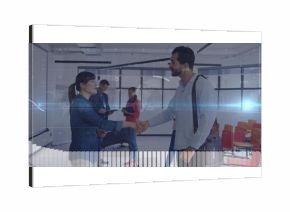 Shaking hands Asian businesswoman and Middle Eastern man in glass conference room, with binders