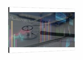 Displaying stethoscope on laptop keyboard at medical office desk, with bar charts and line graphs