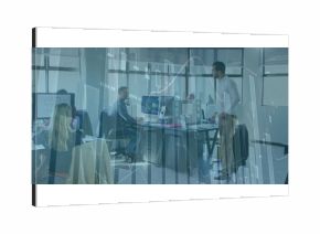 Leading discussion standing man presenting data in open-plan office, with monitors, copy space