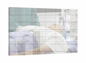 Medical staff settling patient in gown and surgical cap on table in OR with financial overlay