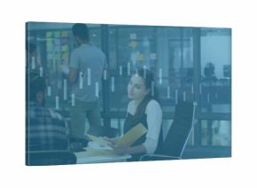 Colleague in business attire reviewing papers at white table in office with post-it glass partition
