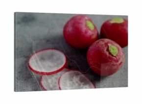 Arranging three red radishes and two radish slices on kitchen countertop, fresh produce
