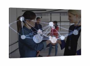 Exchanging handshake between two businesswomen in conference room with digital network overlay