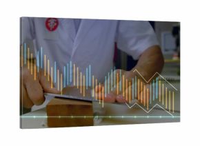 Senior Japanese chef in white coat sharpening knife on whetstone at kitchen counter, with avocado