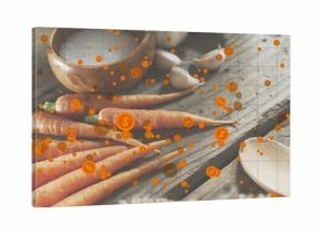 Showing cluster of fresh carrots resting on rustic board at kitchen counter, with dollar icons