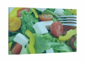 Showing salad on white plate, lettuce, red or yellow tomatoes, yellow pepper, measuring tape