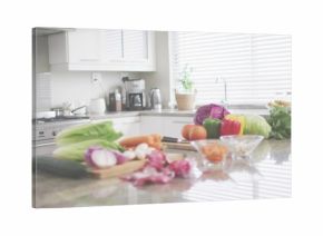 Showcasing center cluster of fresh veggies with cutting board, chef knife on polished stone counter