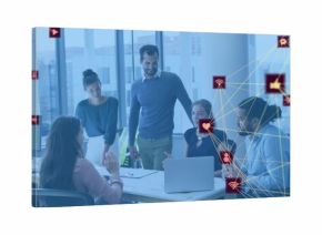 Discussing team wearing business attire around meeting table in modern office, laptop icons