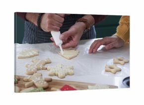 parent is decorating tree-shaped sugar cookie in flat design style, food theme featuring piping bag