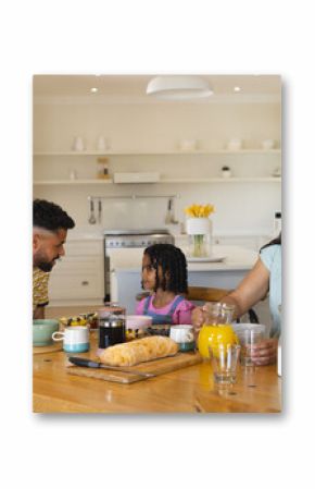 Family enjoying breakfast together at home, smiling and sharing joyful moment