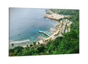 Aerial shot of a resort seashore surrounded by blue ocean and forest, Christmas Island