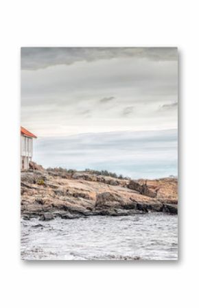 Red house at sea shore in dull colors at autumn