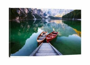 Boats on the Braies Lake ( Pragser Wildsee ) in Dolomites mounta