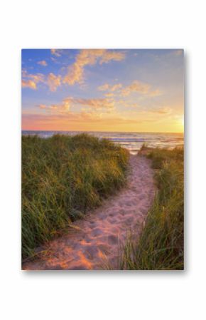 Path To A Summer Sunset Beach. Winding trail through dune grass leads to a sunset beach on the coast of the inland sea of Lake Michigan. Hoffmaster State Park. Muskegon, Michigan.