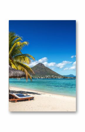 Loungers and umbrella on tropical beach in Mauritius