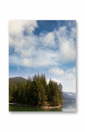 Trees growing by lake and mountains against sky
