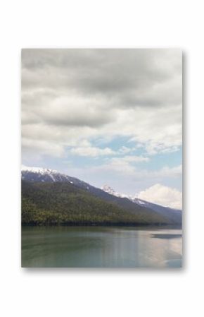 River and snowcapped mountains against cloudy sky