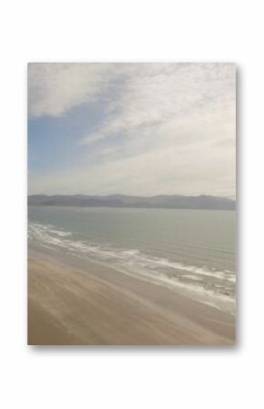 Sea coastline against cloudy sky