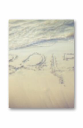 Year carved on sand by shore