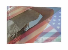 Gazing female beachgoer wearing straw sunhat and red bikini top at shoreline, with flag overlay